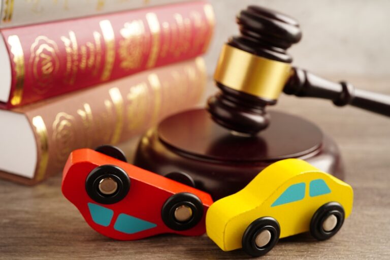 Two books are on a desk that are about Georgia car accident laws.