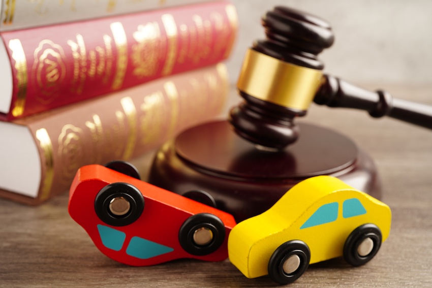 Two books are on a desk that are about Georgia car accident laws.