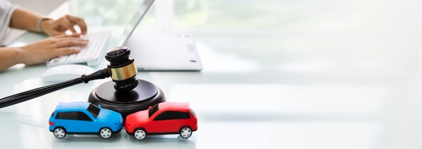 A lawyer is looking over the Georgia car accident laws at her desk at Amircani Law.