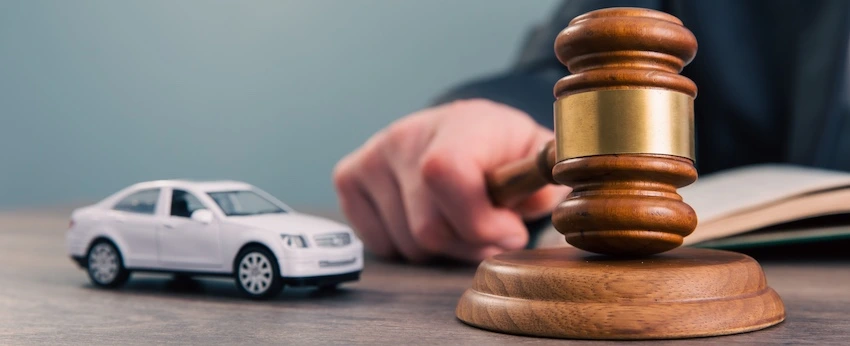 An attorney is looking over a car accident case at his desk.