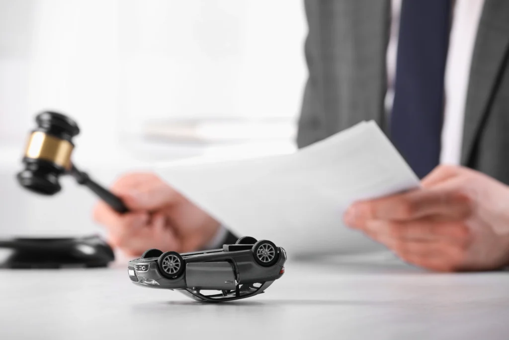 Car accident victim reviewing insurance settlement offer documents with attorney in Atlanta office, evaluating compensation claim